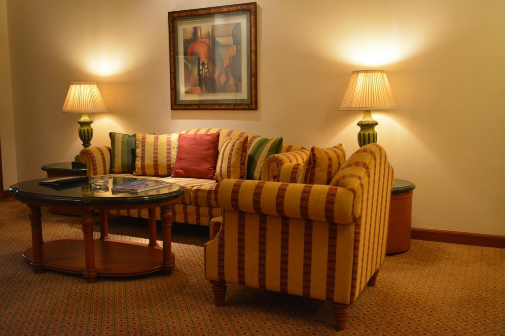 The Orchid Hotel Mumbai Vile Parle Kültér fotó A living room with a sofa
